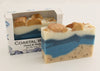 Bars of soap in custom packaging with seashells on top and ocean blue design for the bar