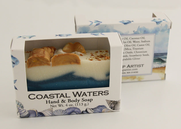 Bars of soap in custom packaging with seashells on top and ocean blue design for the bar