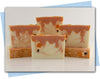 BArs of orange creamsicle soap with a popsicle embeds and design to look like a melting popsicle