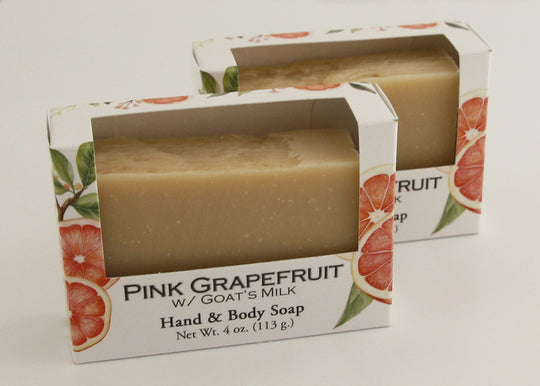 Bars of soap in custom packaging plan orange bar made with milk and no color added