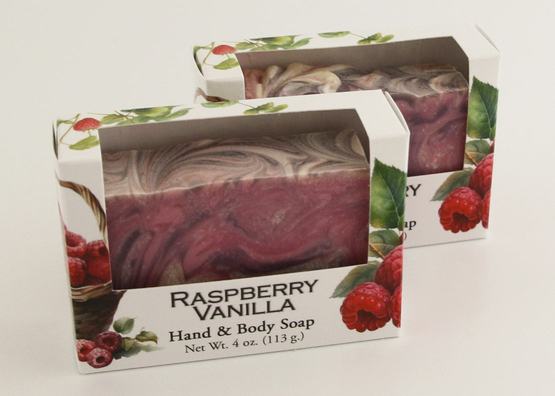 Bars of soap in custom packaging with purple, pink, and white swirl design