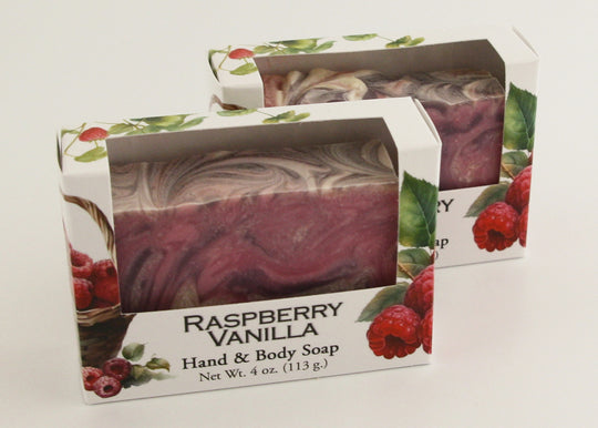 Bars of soap in custom packaging with purple, pink, and white swirl design