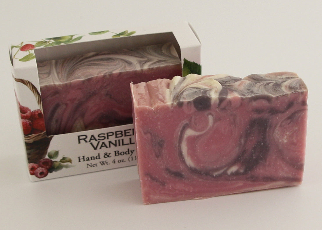 Bars of soap in custom packaging with purple, pink, and white swirl design