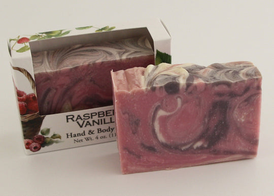 Bars of soap in custom packaging with purple, pink, and white swirl design