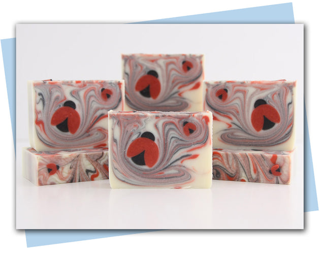 Bars of soap with white red and black swirl and a ladybug embed