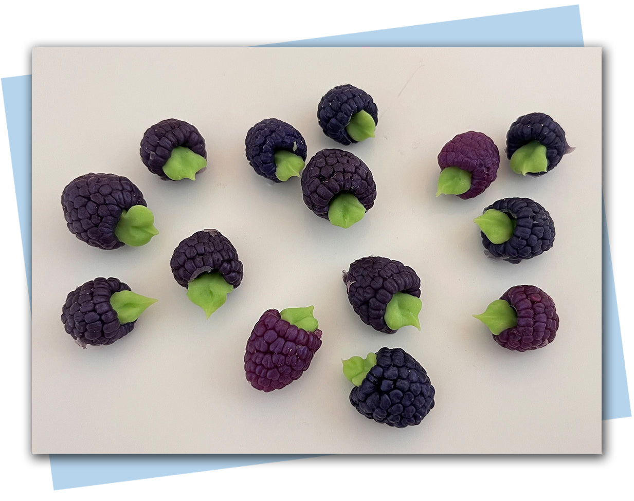dark purple raspberry soaps with green leaves