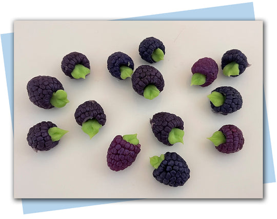 dark purple raspberry soaps with green leaves