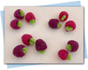 dark pink-purple raspberry soaps with green leaves