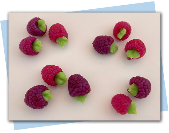 dark pink-purple raspberry soaps with green leaves