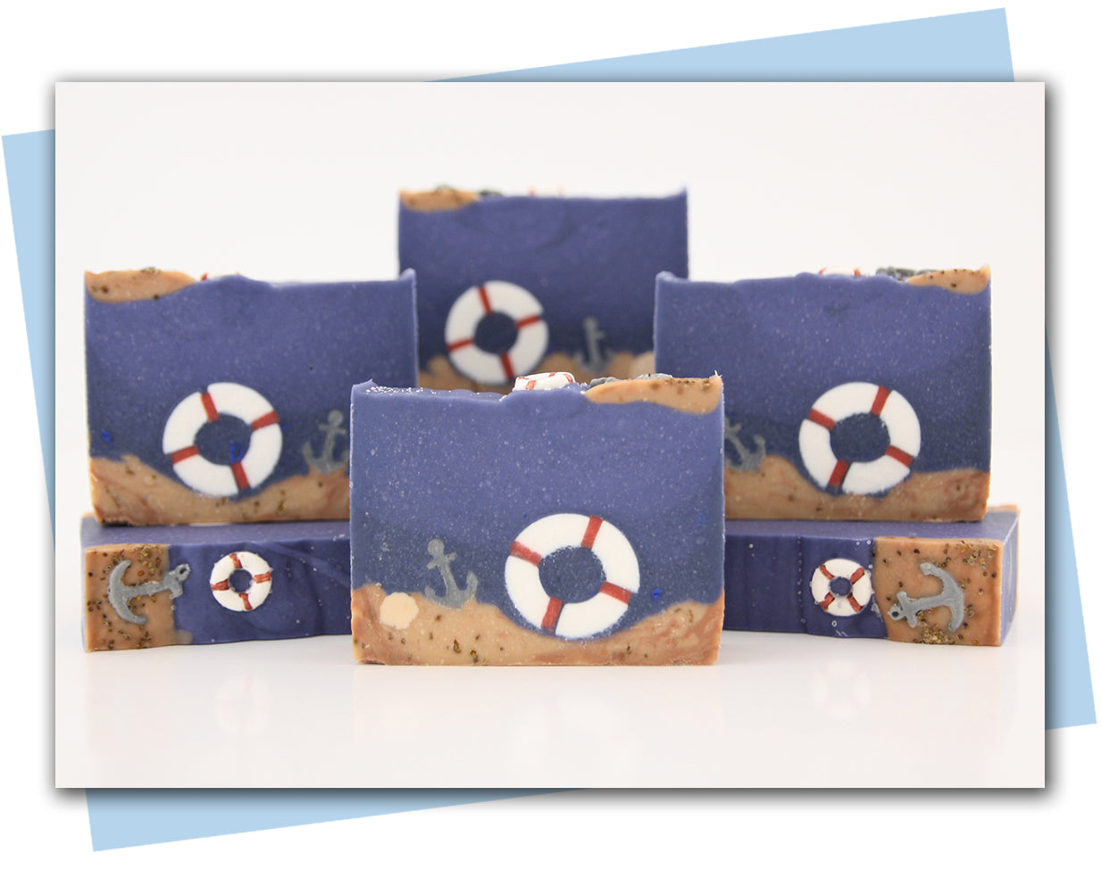 Ocean themed bar of soap with an anchor and life preserver sitting on the ocean sandy floor.
