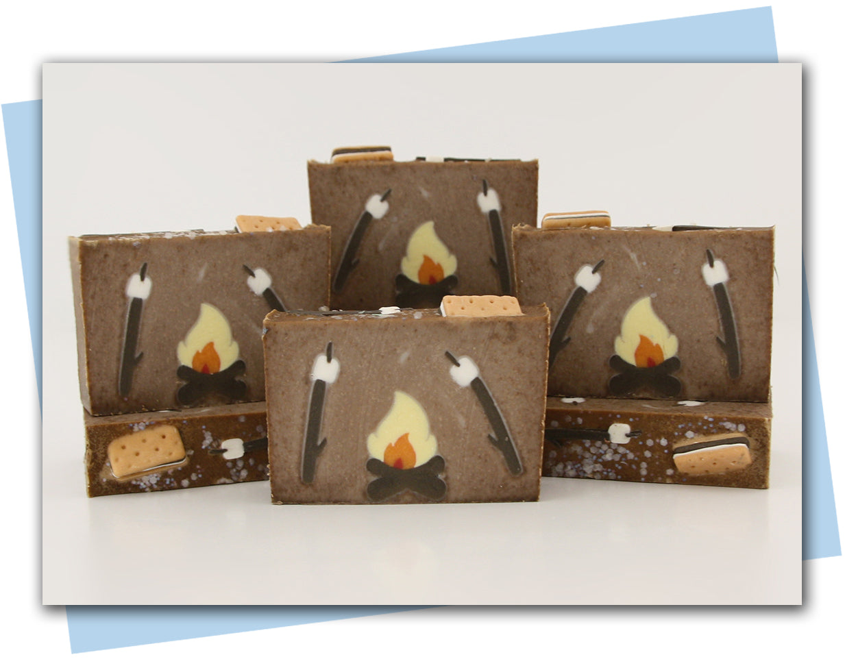 Bars of soap with a s'more design - fire with two sticks with marshmallows.