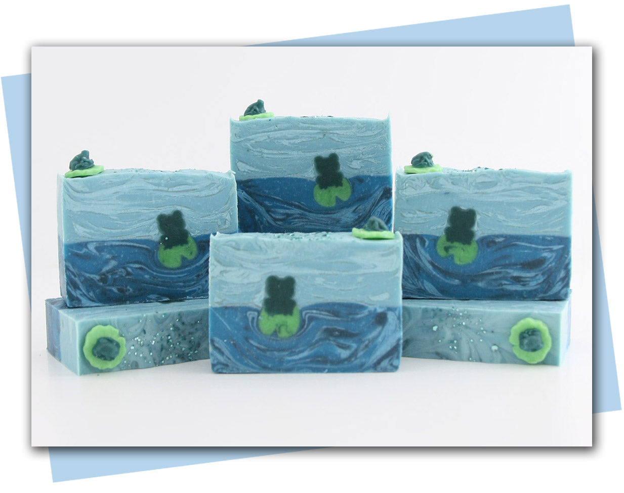 Blue swirled soaps with a frog sitting on a lily pad