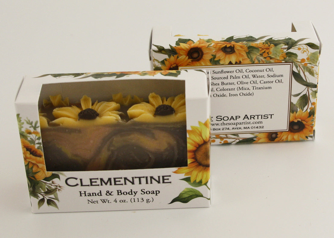 Bars of soap in custom packaging with sunflowers on top and swirl design in brown yellow and orange