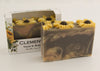 Bars of soap in custom packaging with sunflowers on top and swirl design in brown yellow and orange