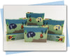 Bars of soap with a camping themed design with a camper, fire, and trees