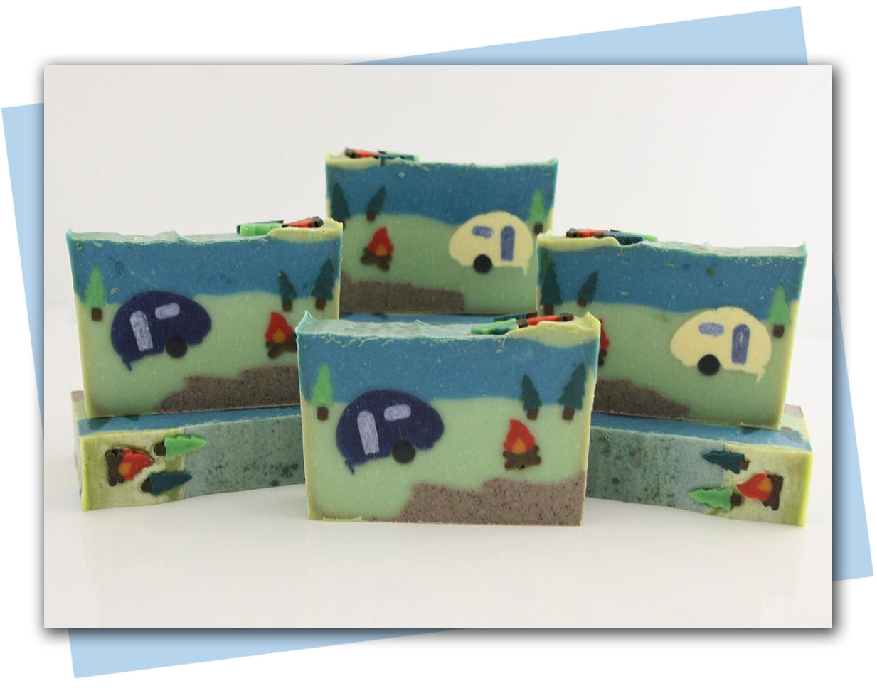 Bars of soap with a camping themed design with a camper, fire, and trees