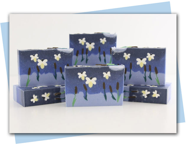 Bars of soap with fireflies flying over a lake with cattails