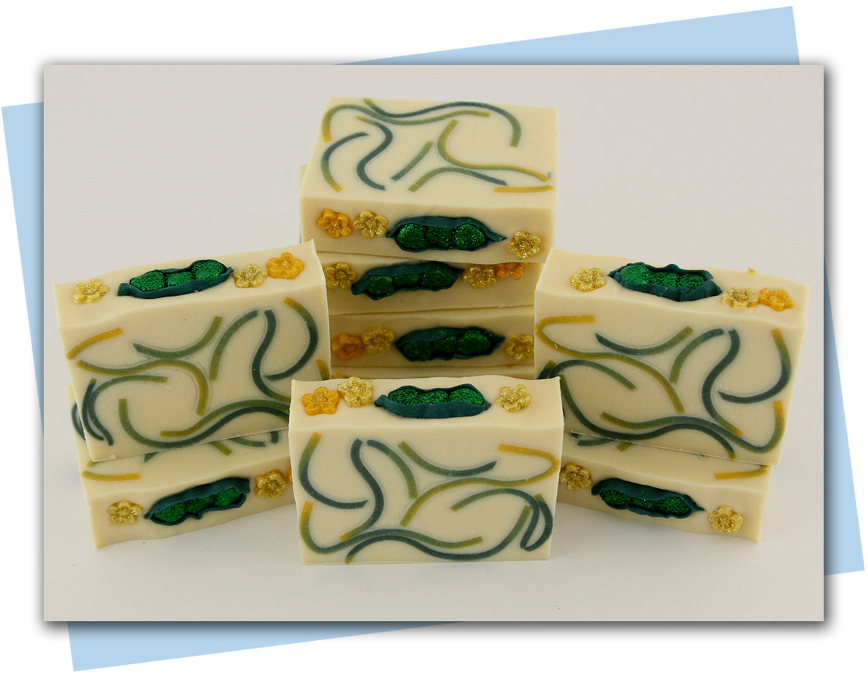 Bars of soap with yellow and green swirled embeds and a peas in a pod top embellishment.