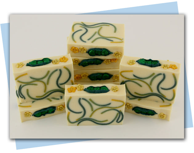 Bars of soap with yellow and green swirled embeds and a peas in a pod top embellishment.