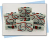 red and green swirls with a tomato and vine top embellishment bars of soap