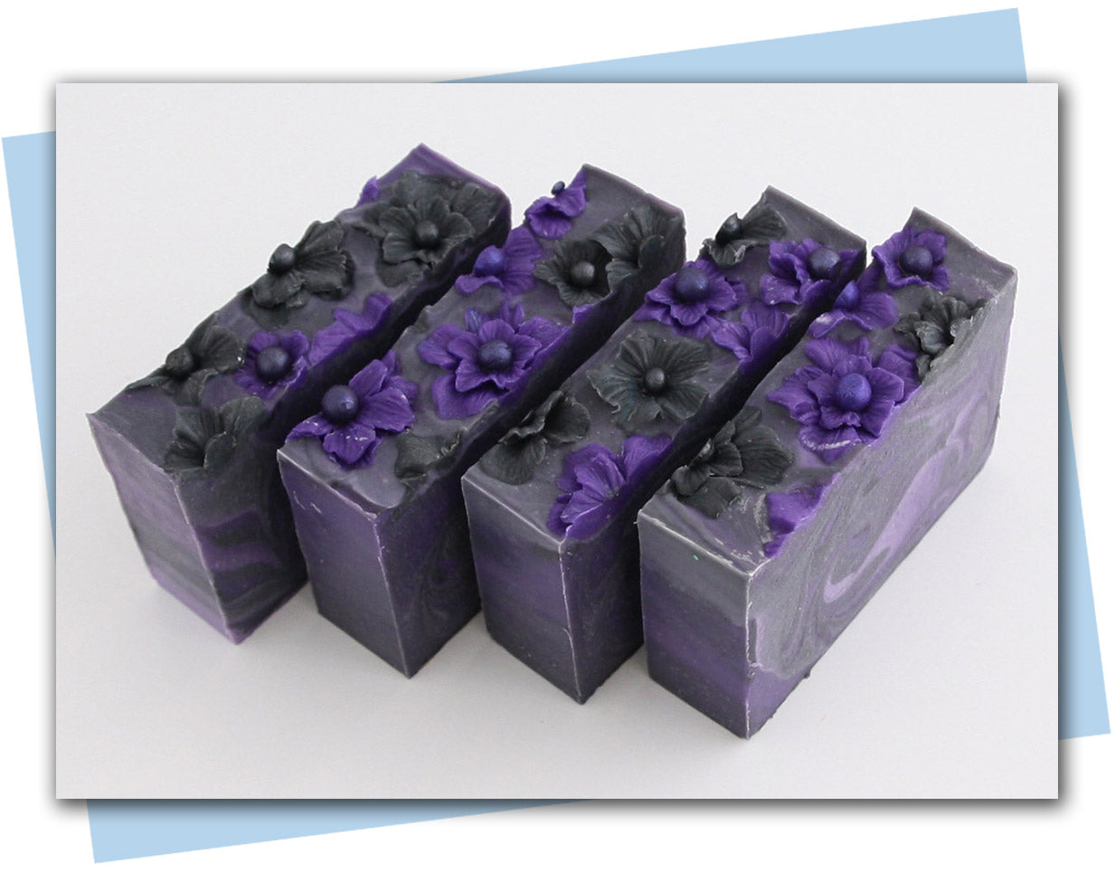 black and purple flowers with a purple to black ombre swirl design bars of soap