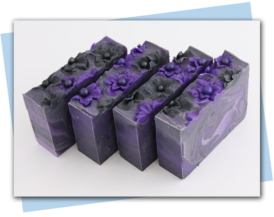 black and purple flowers with a purple to black ombre swirl design bars of soap