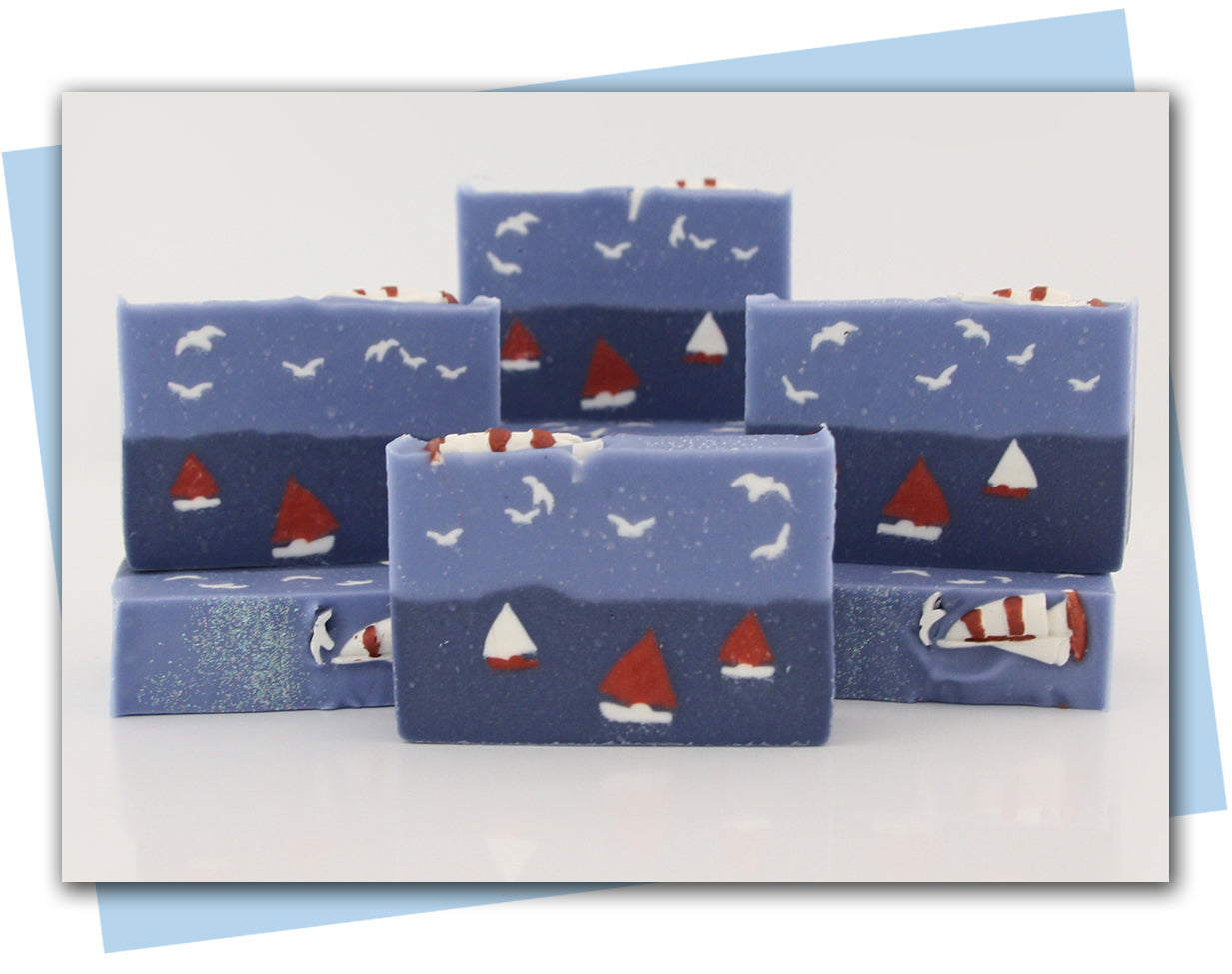sailboats on the ocean with seagulls in the air bars of soap