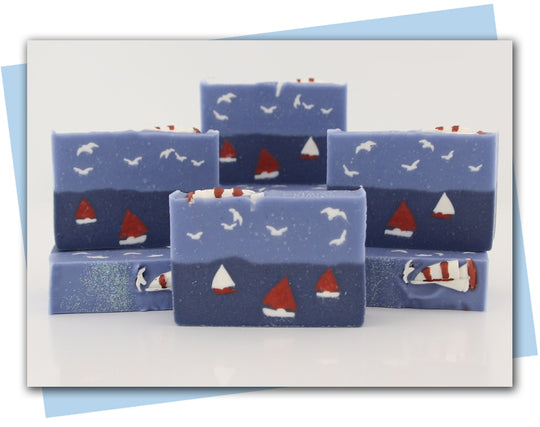 sailboats on the ocean with seagulls in the air bars of soap
