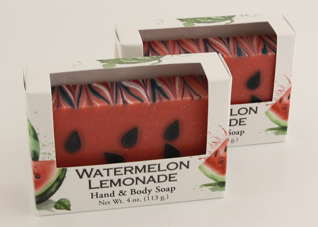 Bars of soap in custom packaging made to look like a watermelon with green bottom layer and black seeds in the pink layer