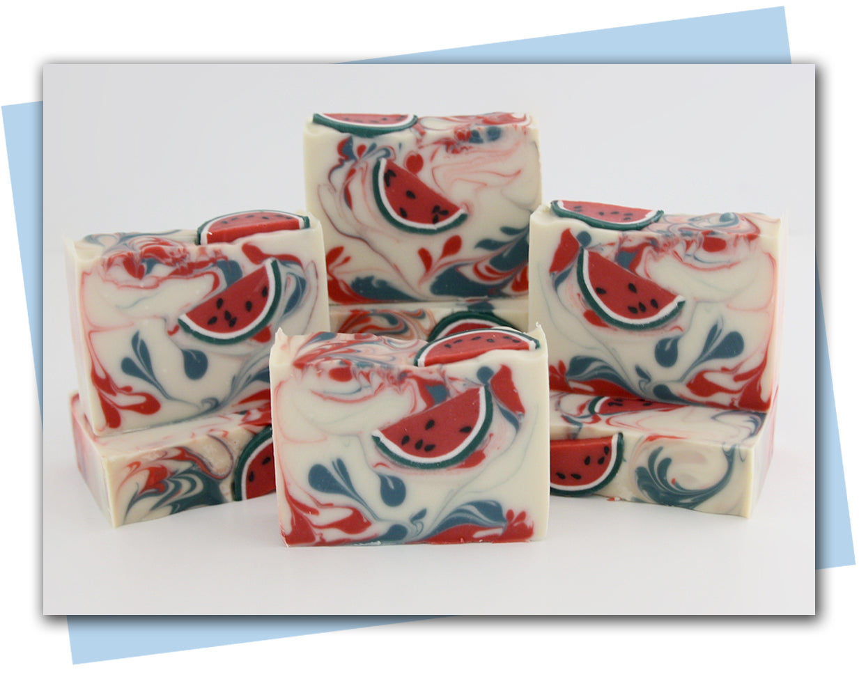 white base soap with red and green swirls and watermelon slice soap embeds