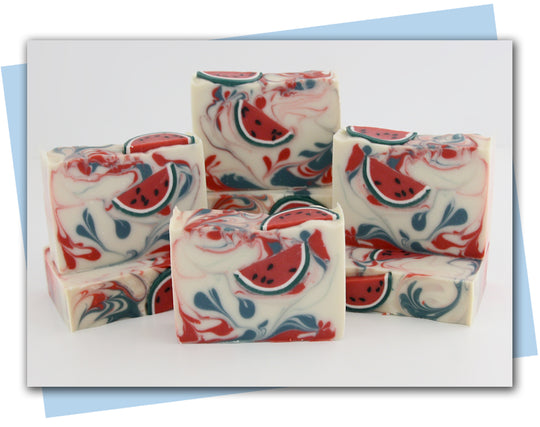 white base soap with red and green swirls and watermelon slice soap embeds